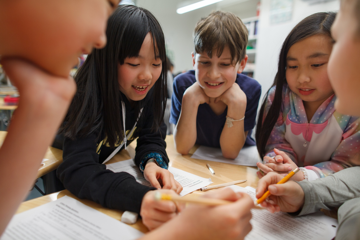 Embrace your Healthy Schools journey! A group of students in a classroom around a desk doing work together